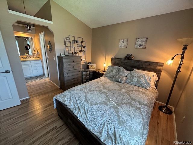 6887 S Dover Way, Littleton, CO 80128 - bedroom featuring wood finished floors, lofted ceiling, arched walkways, a sink, and baseboards