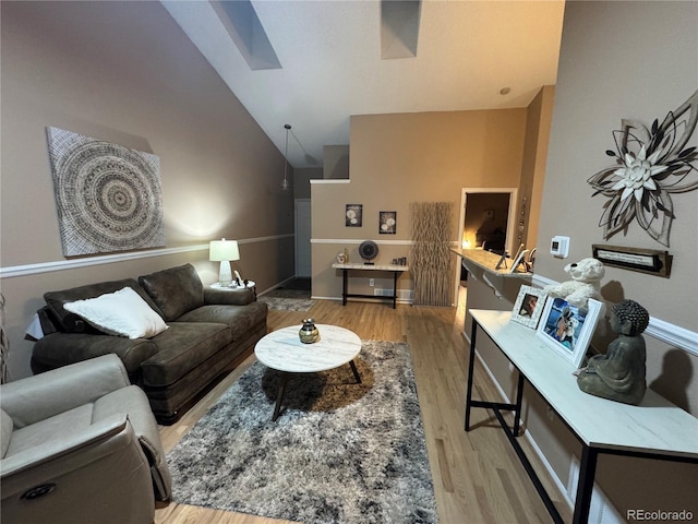 6887 S Dover Way, Littleton, CO 80128 - living area with vaulted ceiling, a skylight, and wood finished floors
