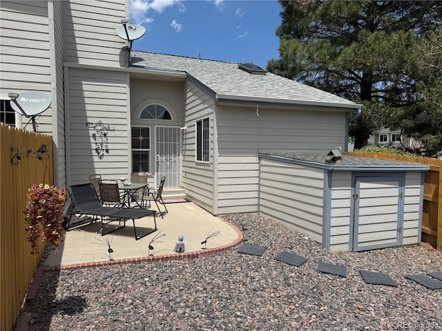 6887 S Dover Way, Littleton, CO 80128 - rear view of house with roof with shingles and a patio area