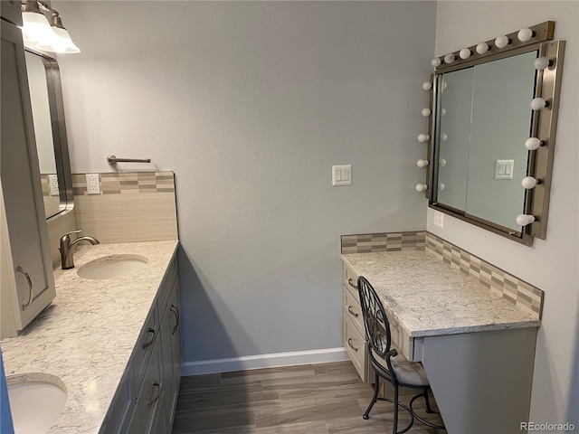 bathroom with double vanity and hardwood / wood-style floors