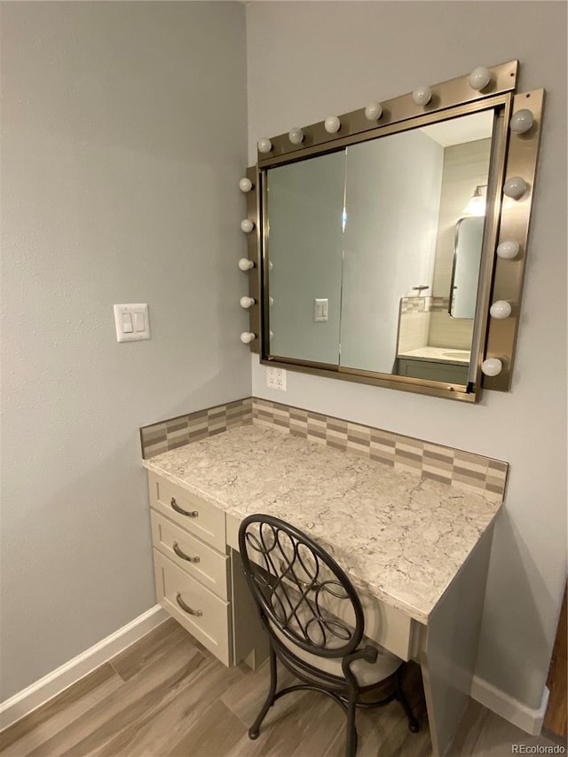 bathroom with hardwood / wood-style floors and vanity