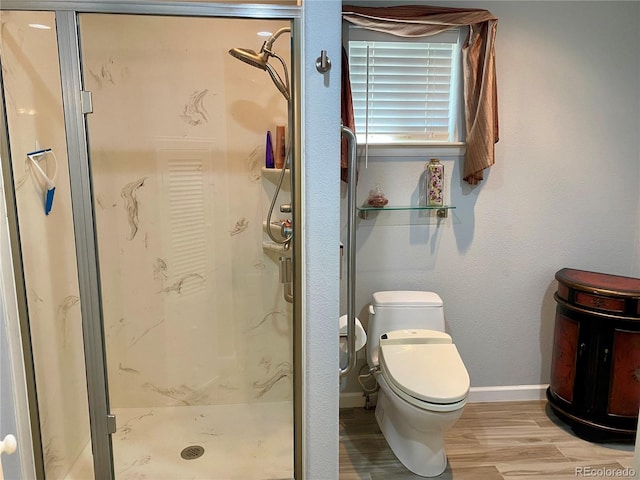 bathroom with wood-type flooring, toilet, and an enclosed shower