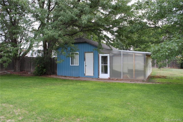 view of outbuilding with a yard