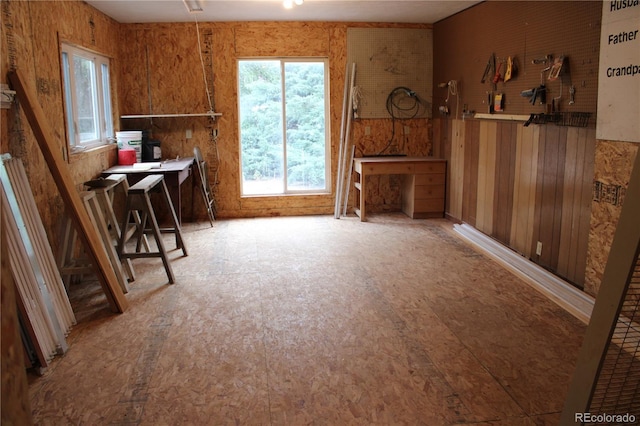 misc room featuring wood walls