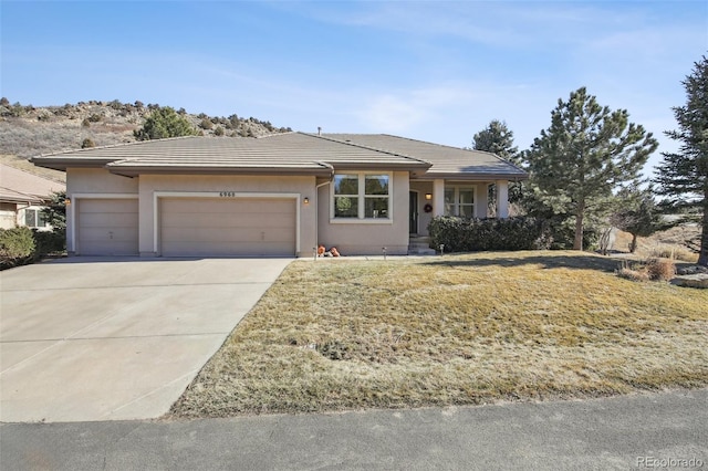 view of front of home featuring a garage and a front lawn