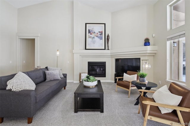 carpeted living room featuring high vaulted ceiling