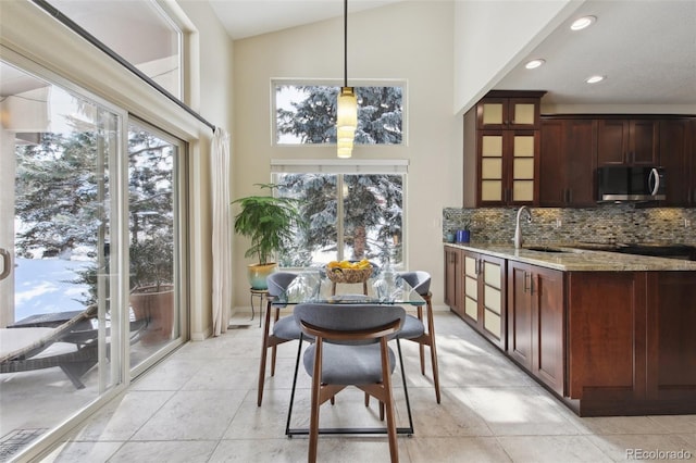 interior space with high vaulted ceiling, a healthy amount of sunlight, and sink