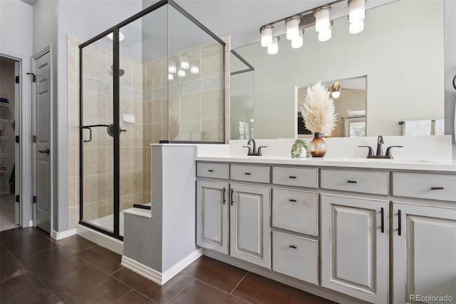 bathroom with tile patterned flooring, vanity, and walk in shower