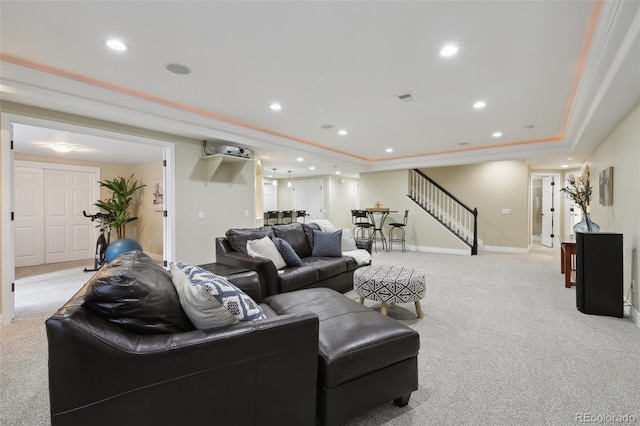 carpeted living room featuring a raised ceiling