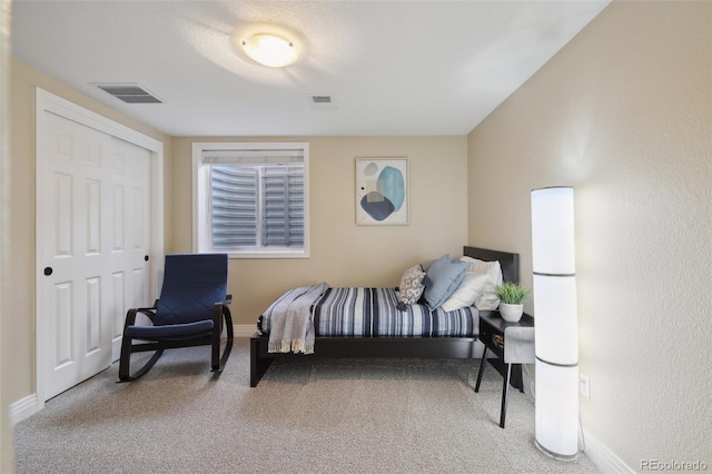 bedroom with carpet floors and a closet