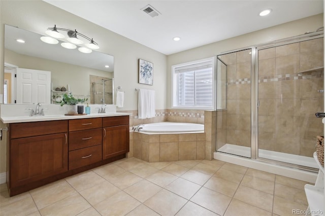 bathroom featuring tile patterned floors, separate shower and tub, and vanity