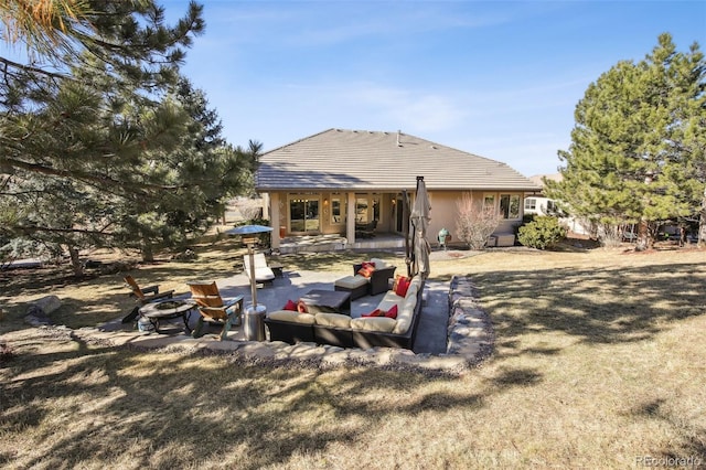 back of property featuring an outdoor hangout area, a patio, and a lawn