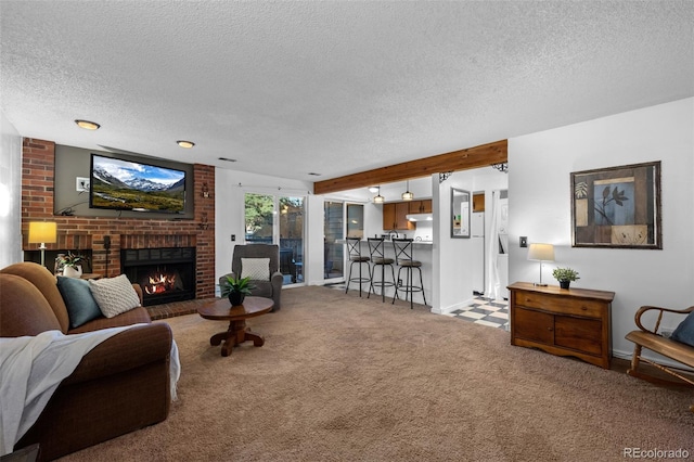 4899 S Dudley St Unit 3A, Littleton, CO 80123 - living area featuring a textured ceiling, carpet flooring, a fireplace, and baseboards