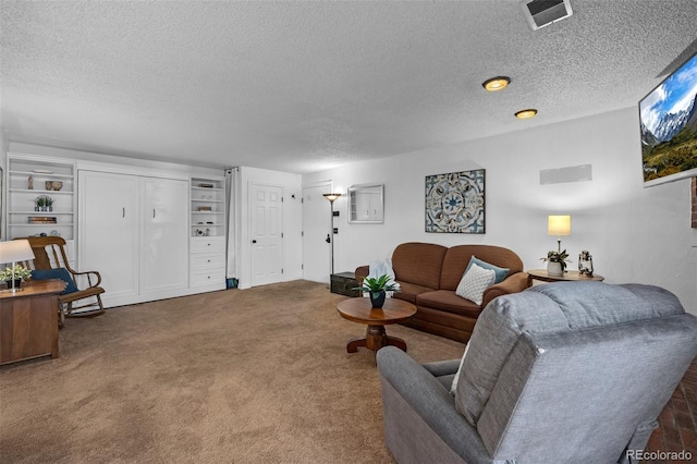 4899 S Dudley St Unit 3A, Littleton, CO 80123 - living area featuring a textured ceiling and carpet