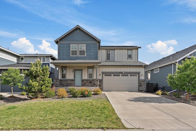 26789 E Cedar Ave, Aurora, CO 80018 - view of front of home with board and batten siding, stone siding, and concrete driveway