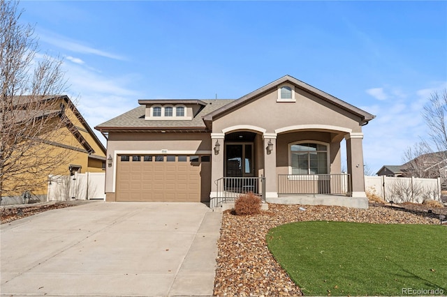 view of front of house with a porch, fence, driveway, and stucco siding