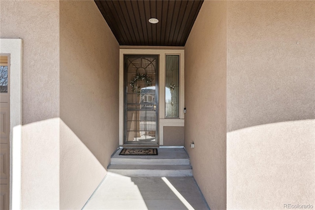 property entrance featuring stucco siding