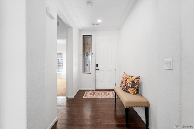 foyer featuring dark wood finished floors, visible vents, and baseboards