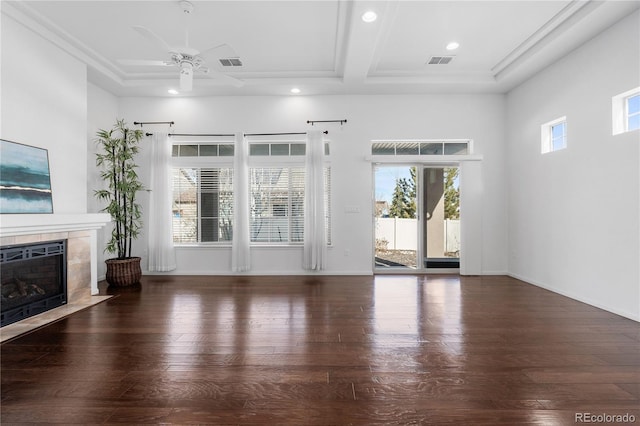 unfurnished living room featuring visible vents, a ceiling fan, wood finished floors, and a tiled fireplace