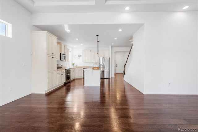 kitchen with dark wood-style floors, recessed lighting, stainless steel appliances, light countertops, and a center island