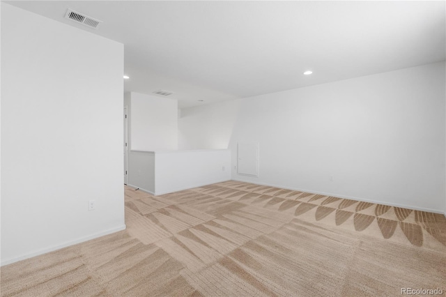 spare room featuring carpet flooring, recessed lighting, visible vents, and baseboards