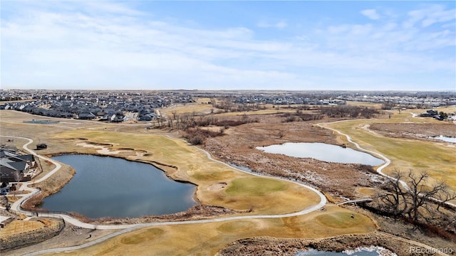 birds eye view of property featuring view of golf course and a water view