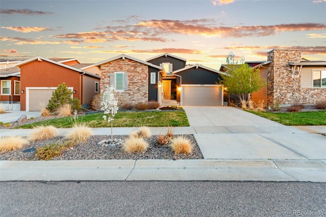 17720 W 94th Dr, Arvada, CO 80007 - view of front of home featuring stone siding, an attached garage, and driveway