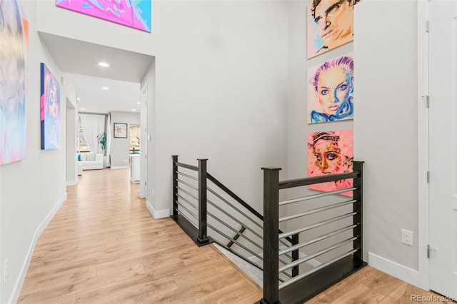 17720 W 94th Dr, Arvada, CO 80007 - hallway featuring an upstairs landing, wood finished floors, baseboards, and recessed lighting