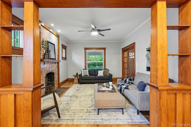 3928 Zuni St, Denver, CO 80211 - living area featuring a large fireplace, wood finished floors, ceiling fan, baseboards, and crown molding