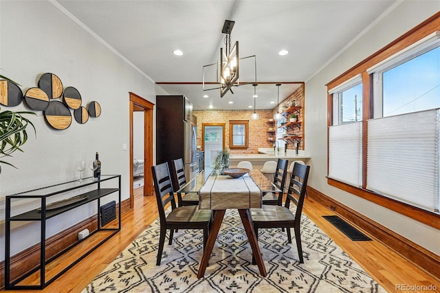 3928 Zuni St, Denver, CO 80211 - dining room featuring light wood-style flooring, crown molding, a chandelier, baseboards, and recessed lighting