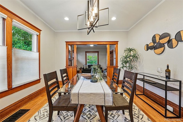 3928 Zuni St, Denver, CO 80211 - dining area with wood finished floors, a chandelier, baseboards, recessed lighting, and ornamental molding