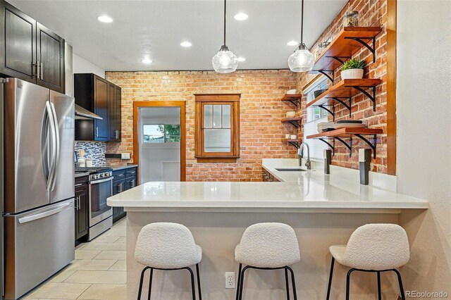 3928 Zuni St, Denver, CO 80211 - kitchen featuring appliances with stainless steel finishes, open shelves, recessed lighting, a peninsula, and a sink