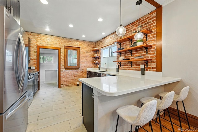 3928 Zuni St, Denver, CO 80211 - kitchen with appliances with stainless steel finishes, open shelves, a sink, a peninsula, and a kitchen bar