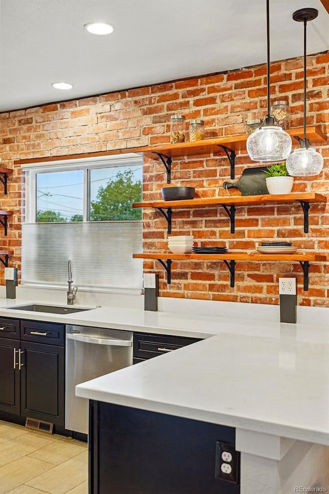 3928 Zuni St, Denver, CO 80211 - kitchen featuring dishwasher, dark cabinets, light countertops, a sink, and decorative light fixtures