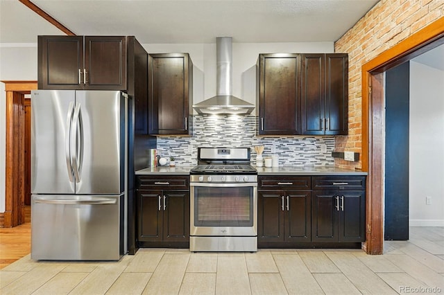 3928 Zuni St, Denver, CO 80211 - kitchen featuring stainless steel appliances, wall chimney exhaust hood, tasteful backsplash, light wood-style flooring, and light countertops