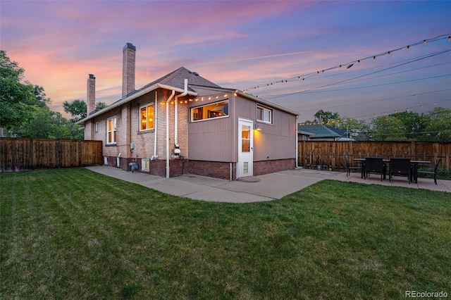 3928 Zuni St, Denver, CO 80211 - back of house featuring a patio, a chimney, and brick siding