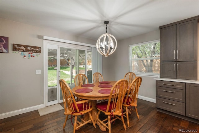 dining space with a chandelier, baseboards, and dark wood-style floors
