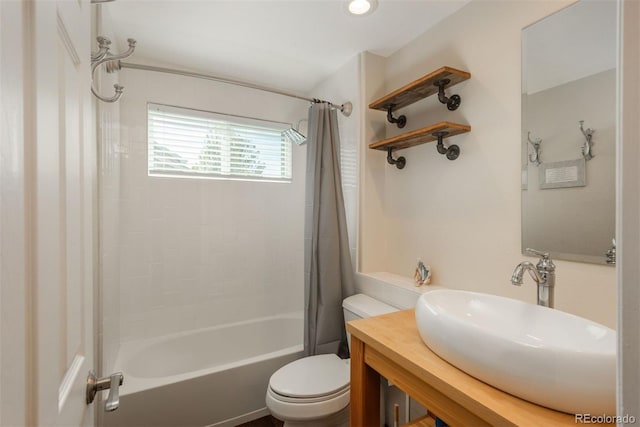 full bathroom featuring toilet, shower / tub combo with curtain, and vanity
