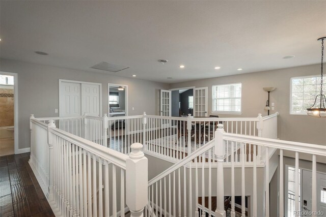 hallway with an upstairs landing, hardwood / wood-style flooring, healthy amount of natural light, and recessed lighting