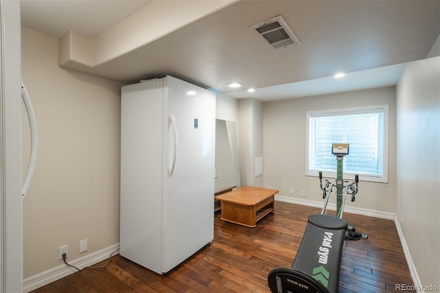 exercise area featuring hardwood / wood-style floors, baseboards, and recessed lighting