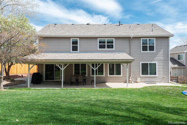 back of house featuring a patio and roof with shingles