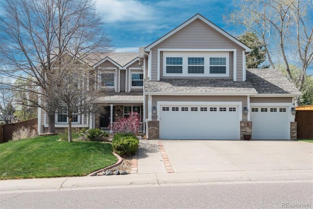 view of front facade with concrete driveway, roof with shingles, an attached garage, and a porch