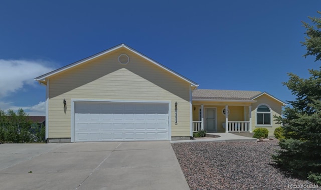 12454 Tex Tan Rd, Peyton, CO 80831 - single story home with covered porch, concrete driveway, and an attached garage