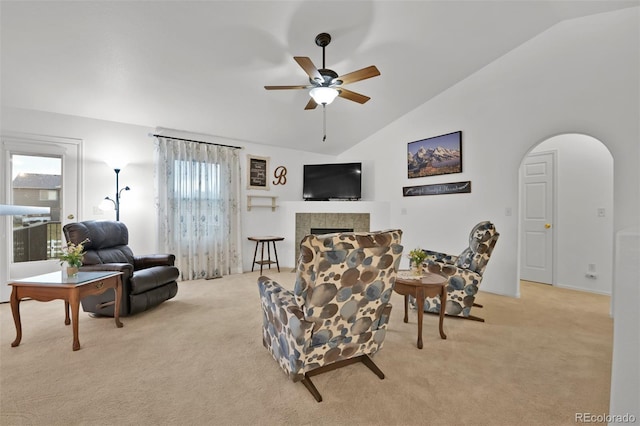 12454 Tex Tan Rd, Peyton, CO 80831 - living room featuring light colored carpet, ceiling fan, healthy amount of natural light, and high vaulted ceiling