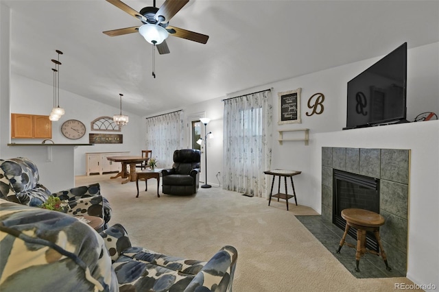 12454 Tex Tan Rd, Peyton, CO 80831 - living area featuring carpet flooring, lofted ceiling, ceiling fan, and a tiled fireplace