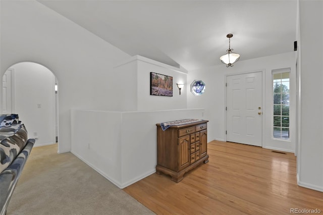 12454 Tex Tan Rd, Peyton, CO 80831 - entryway with vaulted ceiling, light wood-style flooring, arched walkways, and baseboards