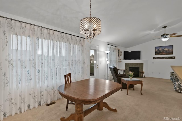 12454 Tex Tan Rd, Peyton, CO 80831 - dining room with healthy amount of natural light, light carpet, lofted ceiling, a tiled fireplace, and a ceiling fan