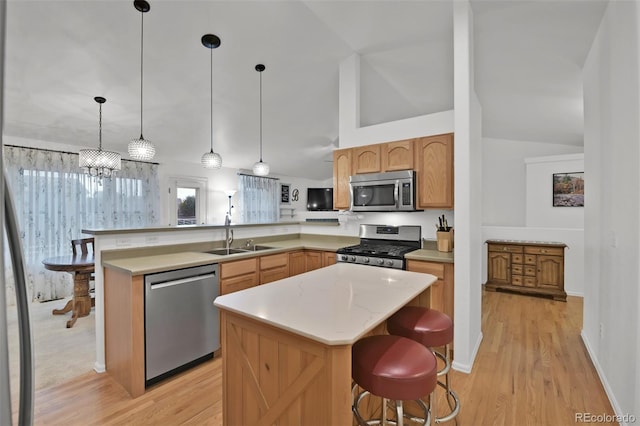 12454 Tex Tan Rd, Peyton, CO 80831 - kitchen featuring stainless steel appliances, a sink, vaulted ceiling, light wood-type flooring, and a peninsula