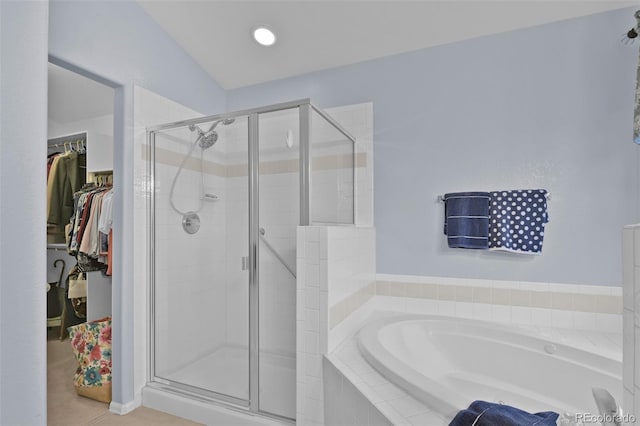 12454 Tex Tan Rd, Peyton, CO 80831 - full bathroom featuring a bath, a stall shower, and a walk in closet