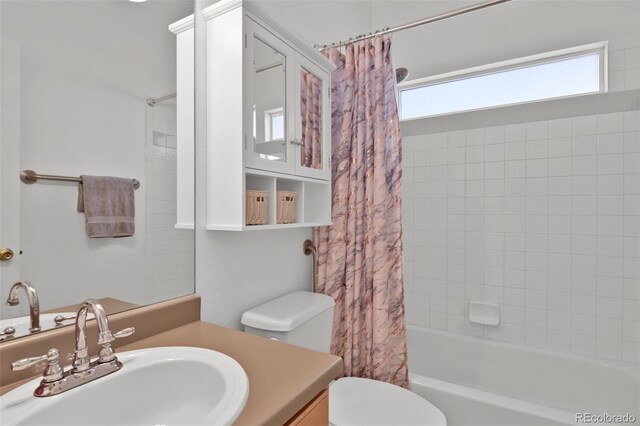 12454 Tex Tan Rd, Peyton, CO 80831 - bathroom with vanity, shower / bathtub combination with curtain, and toilet